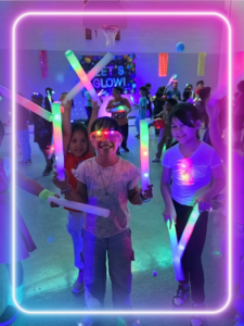 a group of kids smiling with LED lights